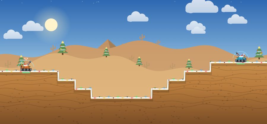 Stepped desert terrain decorated with Christmas trees and lights.